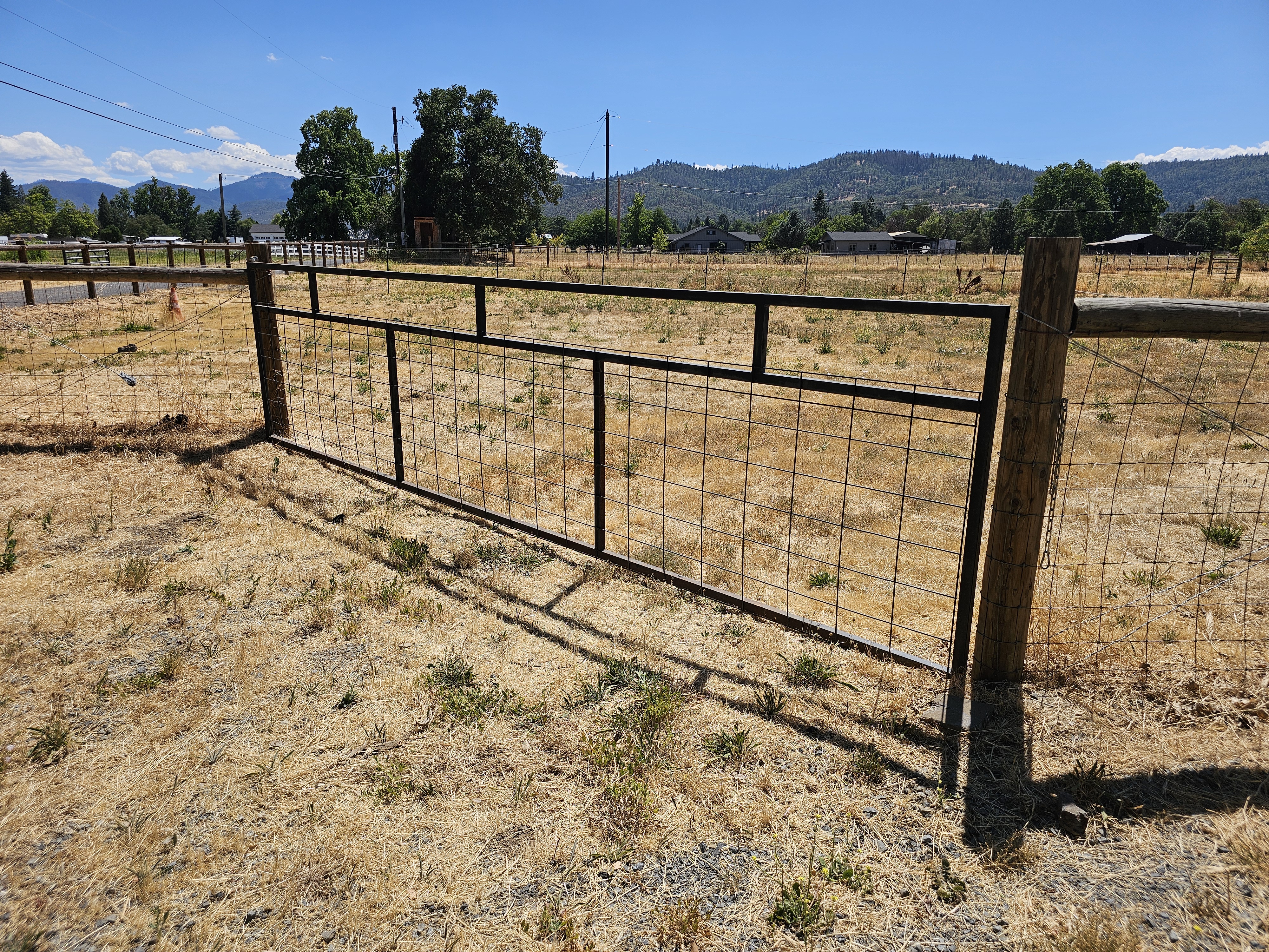 Metal wire gate with mountain backdrop